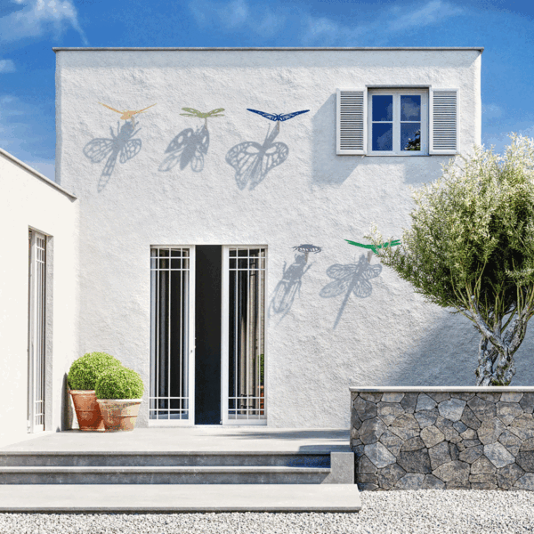 outdoor wall installations in the shape of insects that cast shadows onto the wall