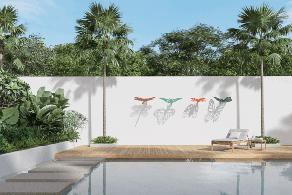 outdoor wall sculptures in the shape of insects that cast shadows onto the wall