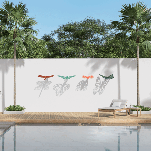 outdoor wall sculptures in the shape of insects that cast shadows onto the wall